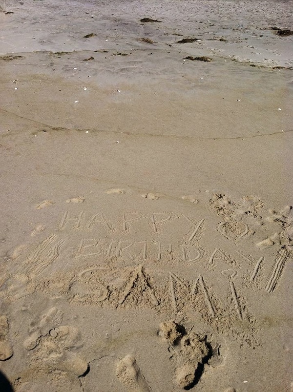happy birthday in sand